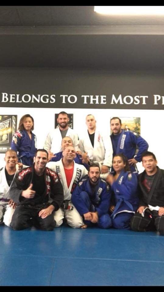 Israel Joffe with his jiu-jitsu training group lined up on the mats